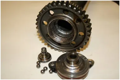 A failed intermediate shaft bearing, disassembled, showing damaged balls and races.