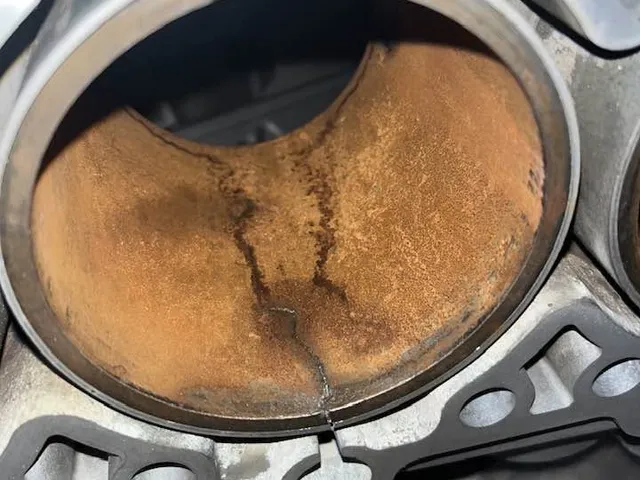 A cylinder with a crack running vertically through the bore and out to the deck face.