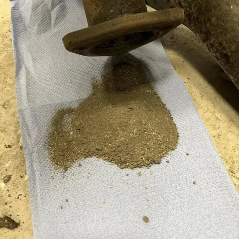 Metal debris tipped from an oil pickup onto a sheet of paper.
