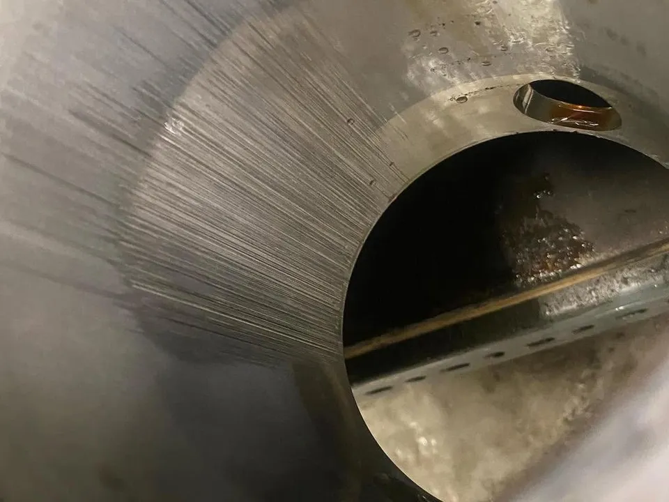 Inside a cylinder, with vertical scoring running down the bore wall.