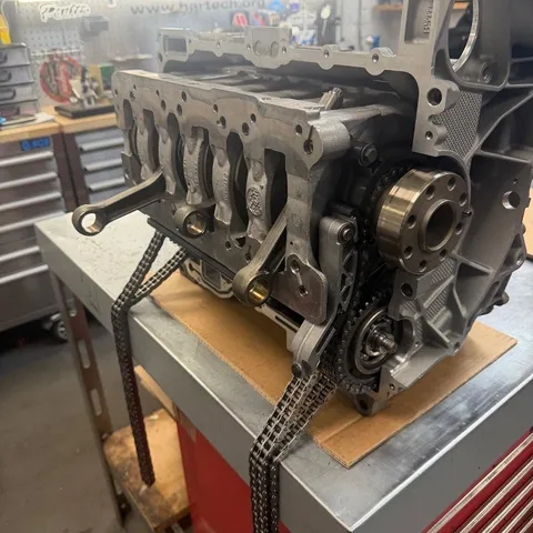 A long block on the engine room bench with the timing chains fitted.