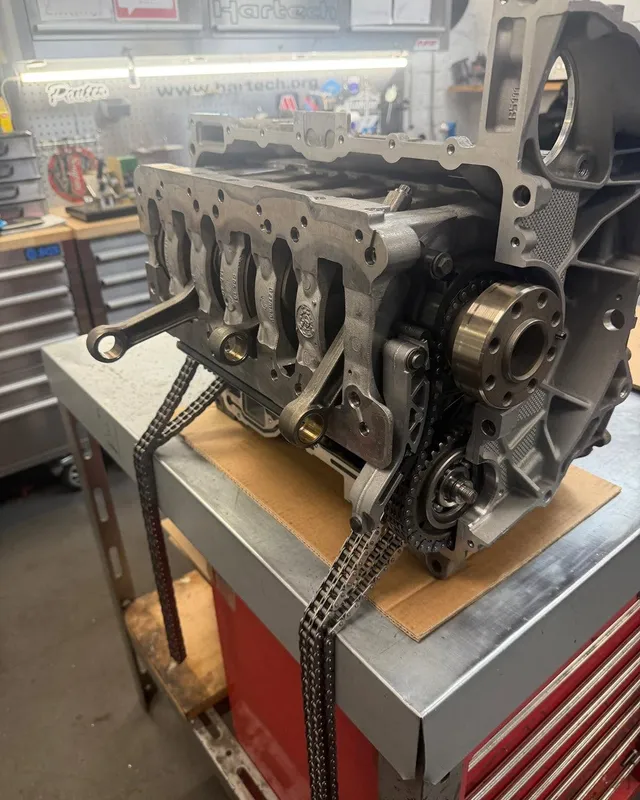 A long block on the engine room bench with the timing chains fitted.