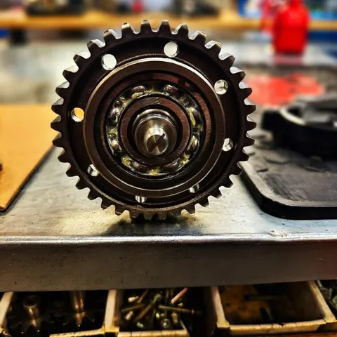 A timing sprocket and chain on the bench.